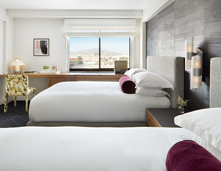 two queen beds in a hotel guestroom